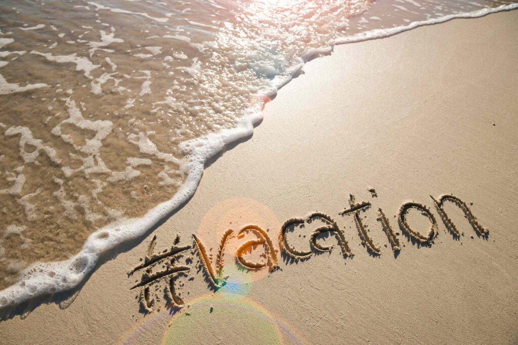 vacation written in sand